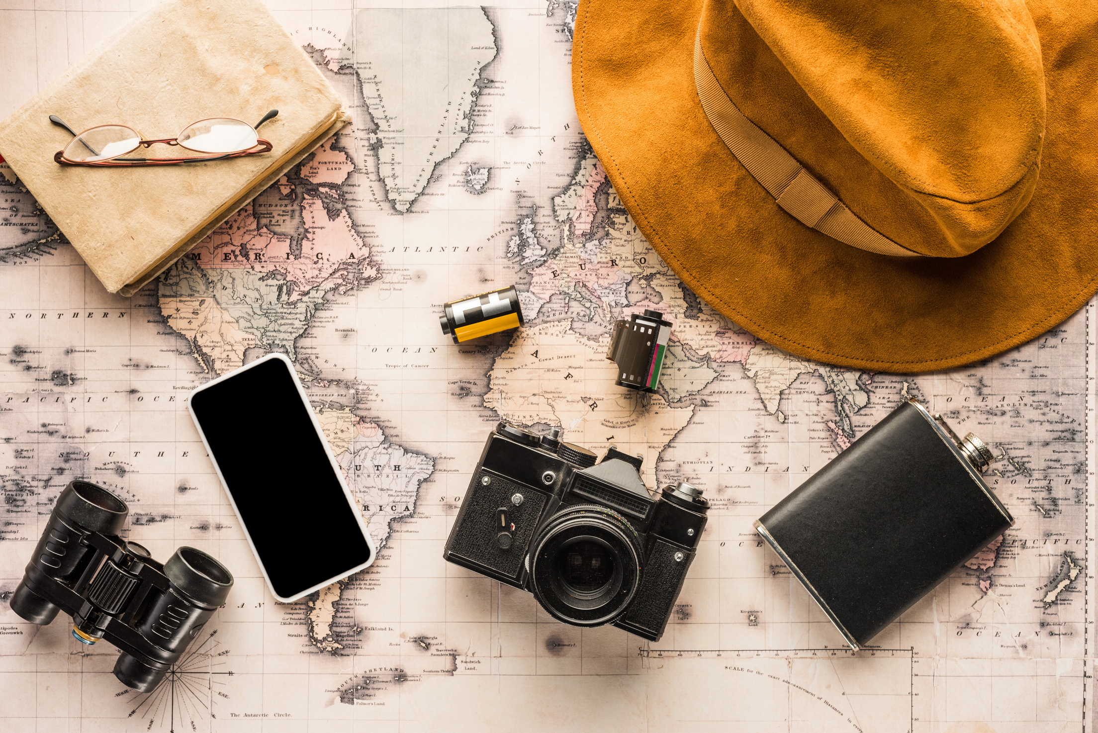 Composition of Travel Essentials Above Map